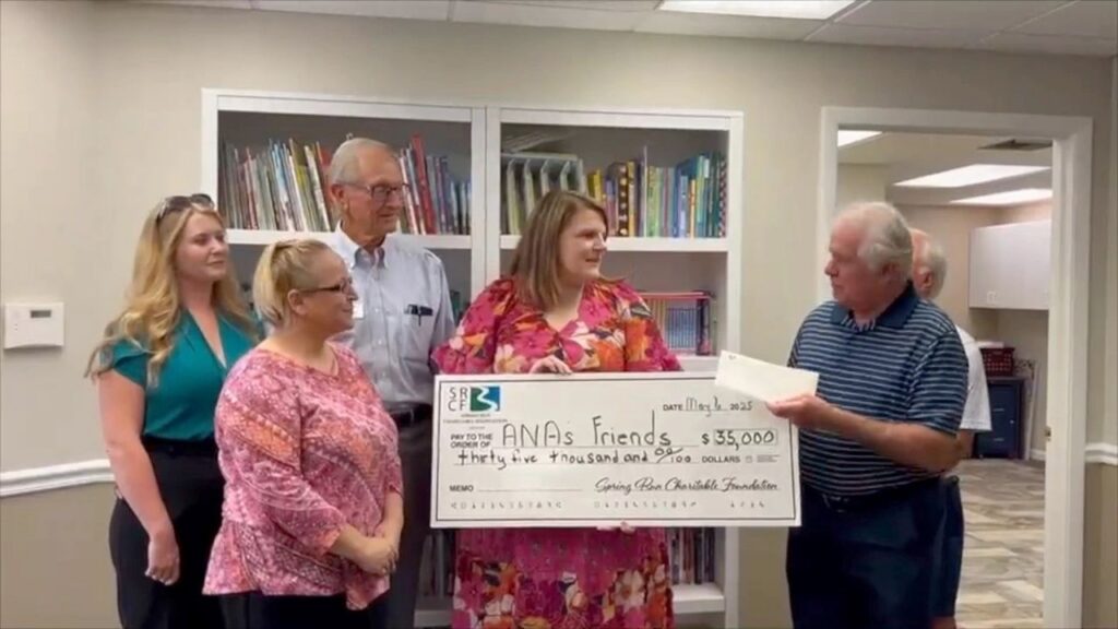SRCF Director Jack Butler presents grant check to Jessica Stanfield, Director of A.N.A.'s Friends.